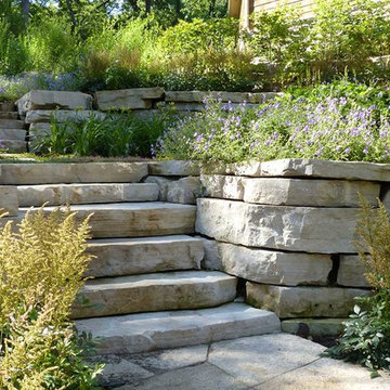 Stone steps made of boulders overfowing with perennials in Bull Valley, IL
