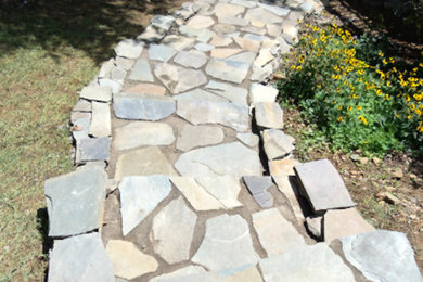 This is an example of a mid-sized drought-tolerant and partial sun stone landscaping in DC Metro.