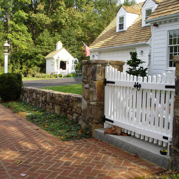 Stone Wall with White Picket Gate
