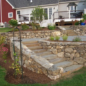 Stone walls, Bluestone Patio, fire pit, this project in Plymouth NH has it all.