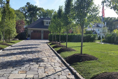 Inspiration for a large craftsman partial sun front yard stone garden path in New York.