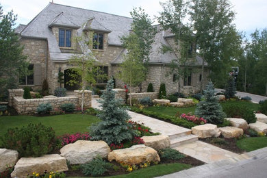 Photo of a large traditional front yard stone garden path in Calgary.
