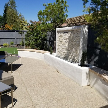 Stucco Sitting Wall with Feature Water Wall next to Putting Green
