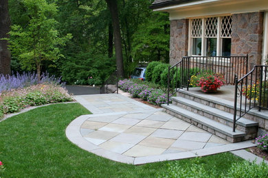 This is an example of a small traditional full sun front yard concrete paver landscaping in New York.