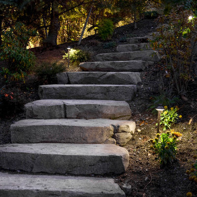 Design ideas for a mid-sized traditional shade hillside stone landscaping in Seattle.
