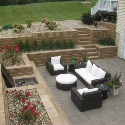 Inspiration for a large traditional side yard concrete paver retaining wall landscape in Minneapolis.