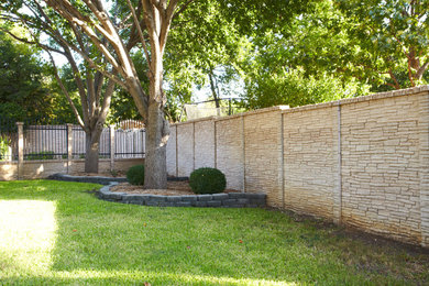 Design ideas for a mid-sized traditional partial sun backyard mulch formal garden in Dallas.