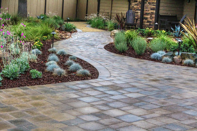 Inspiration for a mid-sized rustic drought-tolerant and full sun front yard concrete paver landscaping in San Diego.