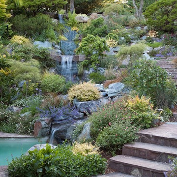 Swimming pool and hillside rock garden with waterfall