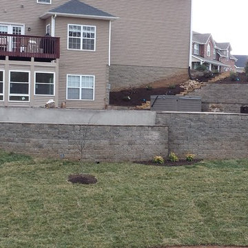 Swimming pool project with retaining walls and patio