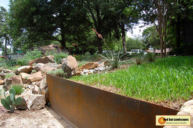 This is an example of a large rustic drought-tolerant and partial sun hillside stone retaining wall landscape.