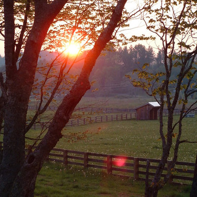 Design ideas for a huge farmhouse backyard landscaping in Charlotte.
