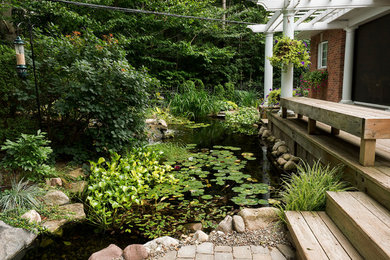 Design ideas for a large mediterranean partial sun backyard concrete paver pond in Other for fall.