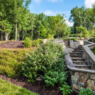 Photo of a traditional hillside stone landscaping in Charlotte.