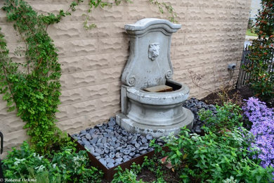 Inspiration for a small traditional drought-tolerant and full sun front yard stone water fountain landscape in Baltimore for fall.