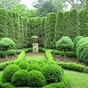 Thuja (arborvitae), fir topiaries, and boxwood parterres