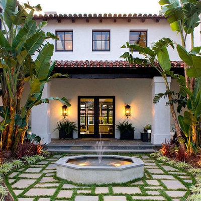 This is an example of a mediterranean front yard water fountain landscape in Los Angeles.