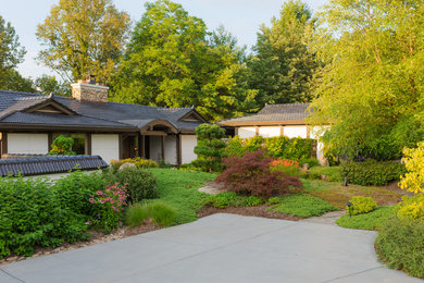 Photo of a mid-sized asian full sun front yard stone landscaping in Charlotte for summer.