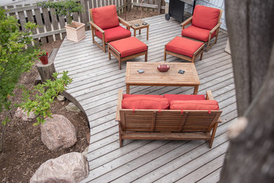 Photo of a mid-sized traditional partial sun backyard landscaping in Milwaukee with decking.