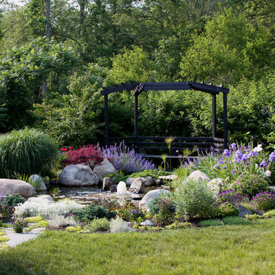 This is an example of a traditional backyard stone water fountain landscape in Boston for summer.