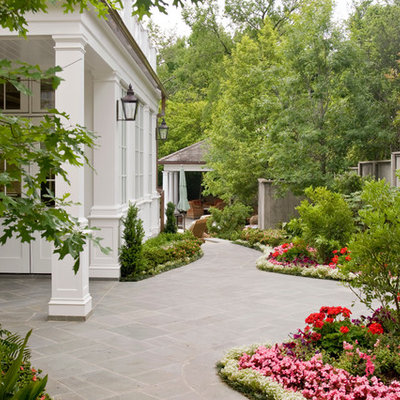 Design ideas for a mid-sized traditional full sun side yard stone formal garden in Dallas for summer.