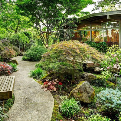 Inspiration for a traditional backyard concrete paver landscaping in Other.