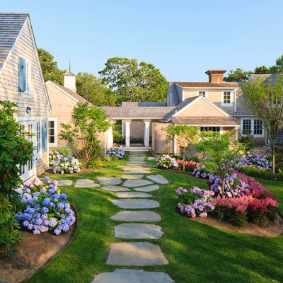 Inspiration for a traditional shade backyard stone landscaping in Boston.