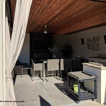 Transformation: Outdoor fireplace, bar, and deck above
