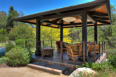Medium sized world-inspired back partial sun garden in Santa Barbara with gravel.