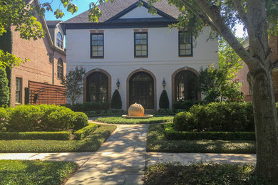This is an example of a large transitional partial sun front yard stone landscaping in Houston.