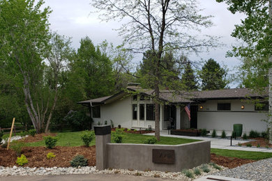 Photo of a mid-sized modern full sun front yard concrete paver walkway in Denver for summer.