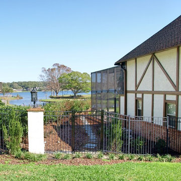 Tudor Revival backyard lakefront landscape design