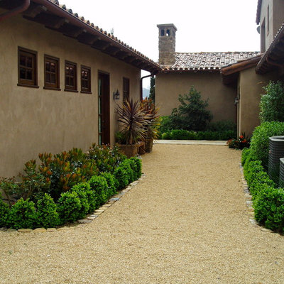 Inspiration for a large mediterranean full sun backyard gravel landscaping in San Diego.