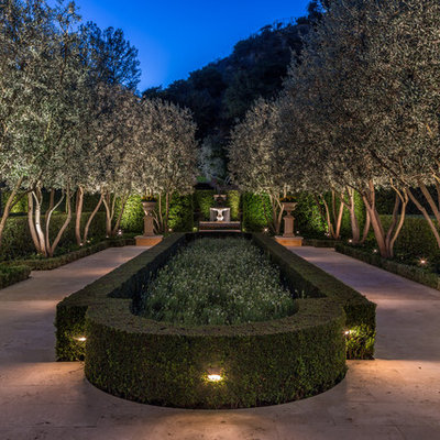 This is an example of a large mediterranean backyard formal garden in Los Angeles.