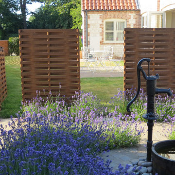 Two contemporary screens to match the woven steel fence beyond