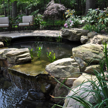 Two-tiered koi pond with plantings and natural stone