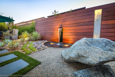 Design ideas for a mid-sized contemporary drought-tolerant and partial sun gravel water fountain landscape in Orange County.