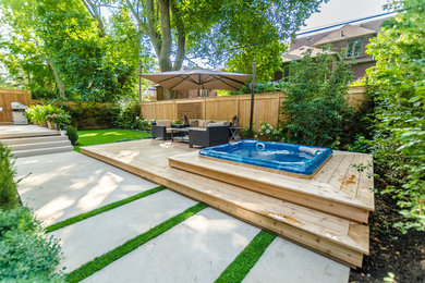 Photo of a mid-sized contemporary partial sun backyard concrete paver formal garden in Toronto for summer.