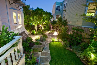 Large contemporary back fully shaded garden in San Francisco with natural stone paving.