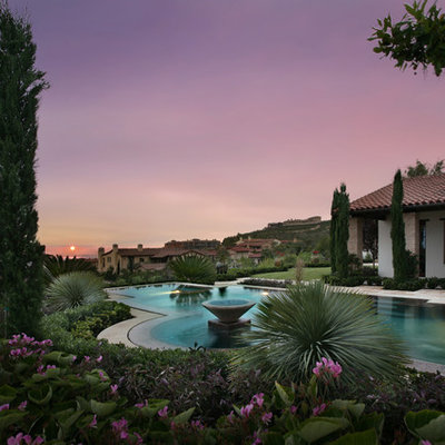 This is an example of a large mediterranean full sun backyard landscaping in Los Angeles.