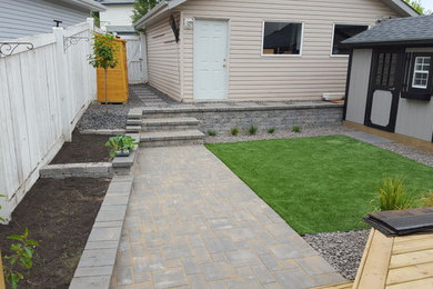Inspiration for a mid-sized craftsman full sun backyard concrete paver retaining wall landscape in Edmonton for spring.