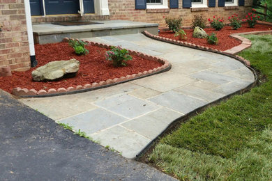 Design ideas for a small traditional full sun front yard stone landscaping in DC Metro for summer.