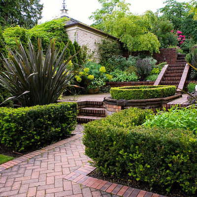 Inspiration for a traditional hillside brick garden path in Seattle.