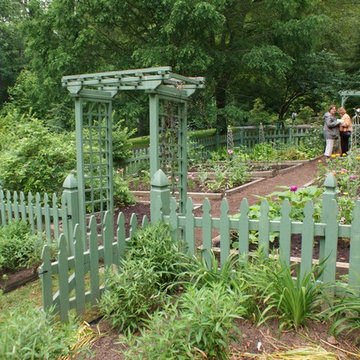 Vegetable garden with a green picket fence