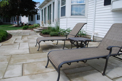 Photo of a large transitional full sun backyard stone landscaping in Cleveland for summer.