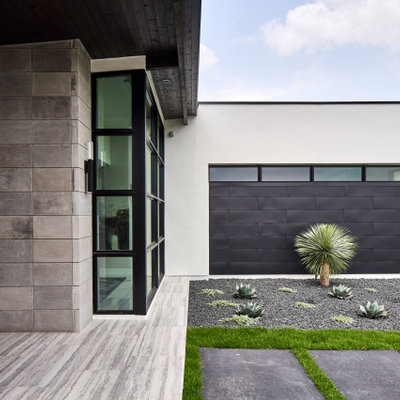 This is an example of a contemporary drought-tolerant and desert front yard gravel landscaping in Other.