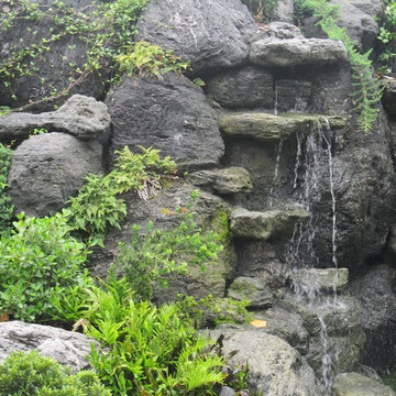 Volcanic rock waterfalls with tropical plantings