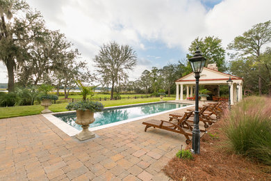 Design ideas for a huge traditional full sun backyard concrete paver landscaping in Charleston.