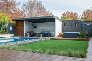 This is an example of a large world-inspired back garden for summer in Sydney with decking.