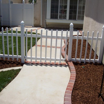 Walkway and front entry with white vinyl picket fence